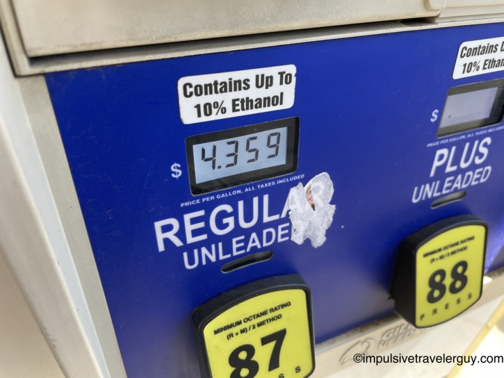 Close-up of a gas pump display showing regular unleaded at $4.359 per gallon, with a 'Contains Up To 10% Ethanol' sticker and yellow octane rating buttons for 87 and 88