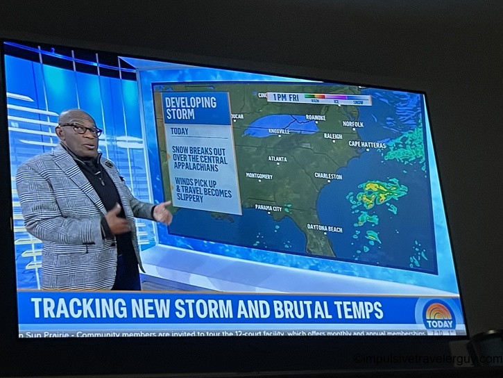 Television displaying NBC&rsquo;s Today Show weather segment with Al Roker presenting. The screen shows "Tracking New Storm and Brutal Temps" headline with a weather map of the southeastern United States showing a developing storm system.