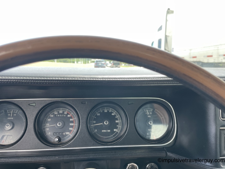 The Cougar's full instrument cluster through the wood-rimmed steering wheel — amps and fuel gauge on the left, 120-mph speedometer in the center showing 78,599 miles on the odometer, tachometer, and the oil/temp combo gauge on the right.