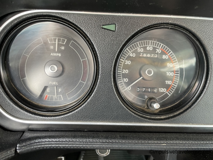 Close-up of the Cougar's amps, fuel, and speedometer gauges after the second fill-up — fuel gauge now reading full, odometer at 78,673 miles, a 74-mile gain from the earlier reading.