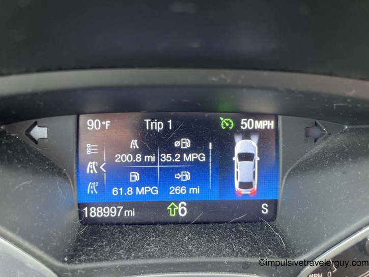 Car dashboard trip computer showing 188,997 total miles, 90 degrees outside temperature, 50 MPH cruise, and 35.2 MPG on the current trip.