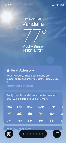 iPhone screenshot of Apple Weather app showing 77 degrees and mostly sunny in Vandalia with a Heat Advisory through Friday July 3rd, high of 92 degrees.