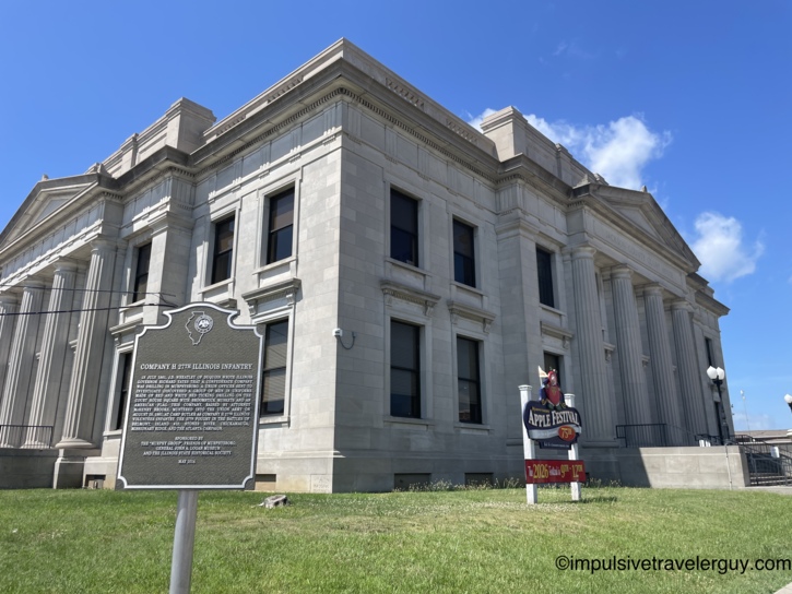 Jackson County Courthouse in Murphysboro, Illinois, a neoclassical limestone building with a Company H 27th Illinois Infantry historical marker and a Murphysboro Apple Festival 75th anniversary sign on the lawn.