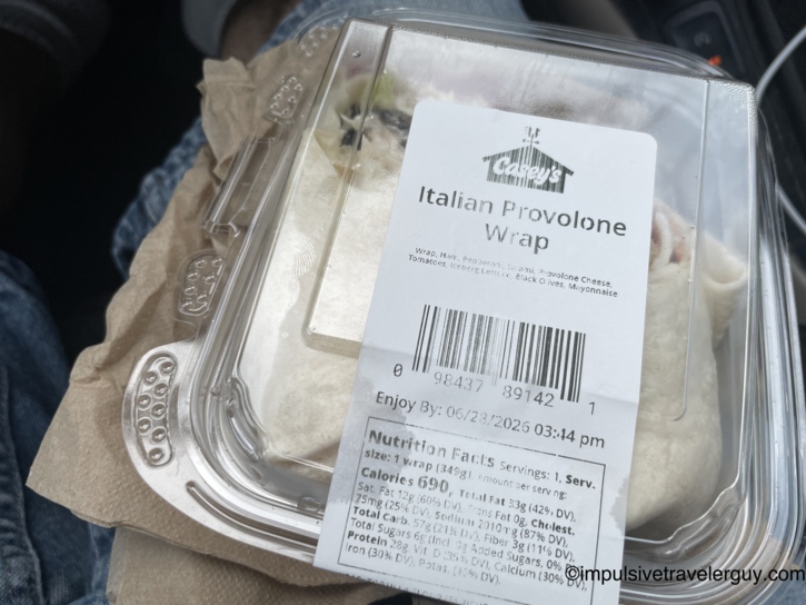 Casey's General Store Italian Provolone Wrap in a clear clamshell container held on lap in the car.