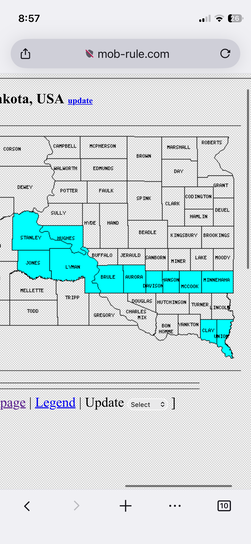 iPhone screenshot of mob-rule.com showing a South Dakota county map with a handful of visited counties highlighted in cyan, mostly clustered along the southern border and central-west area.