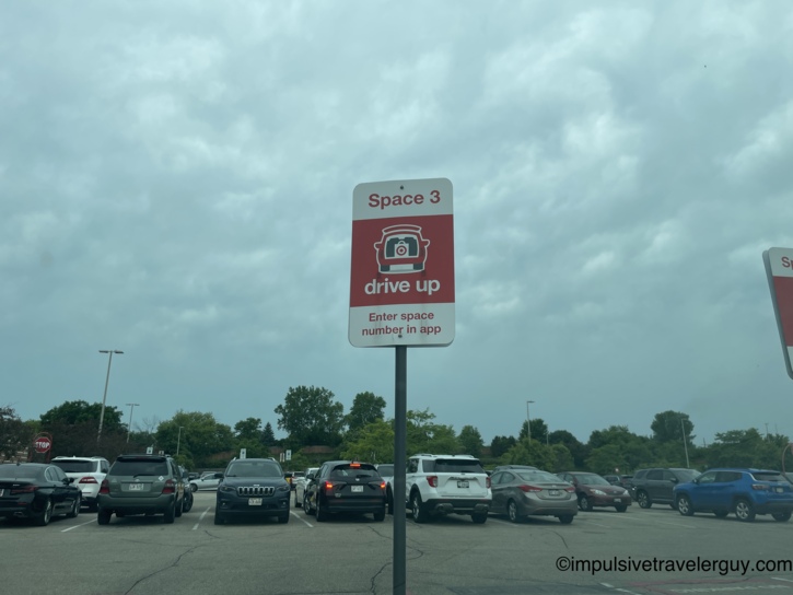 Target Drive Up Space 3 sign in a crowded parking lot under overcast skies.