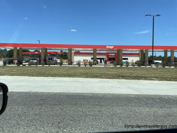 Exterior view of a new Casey's gas station in East Texas featuring a wide red canopy over the fuel pumps.